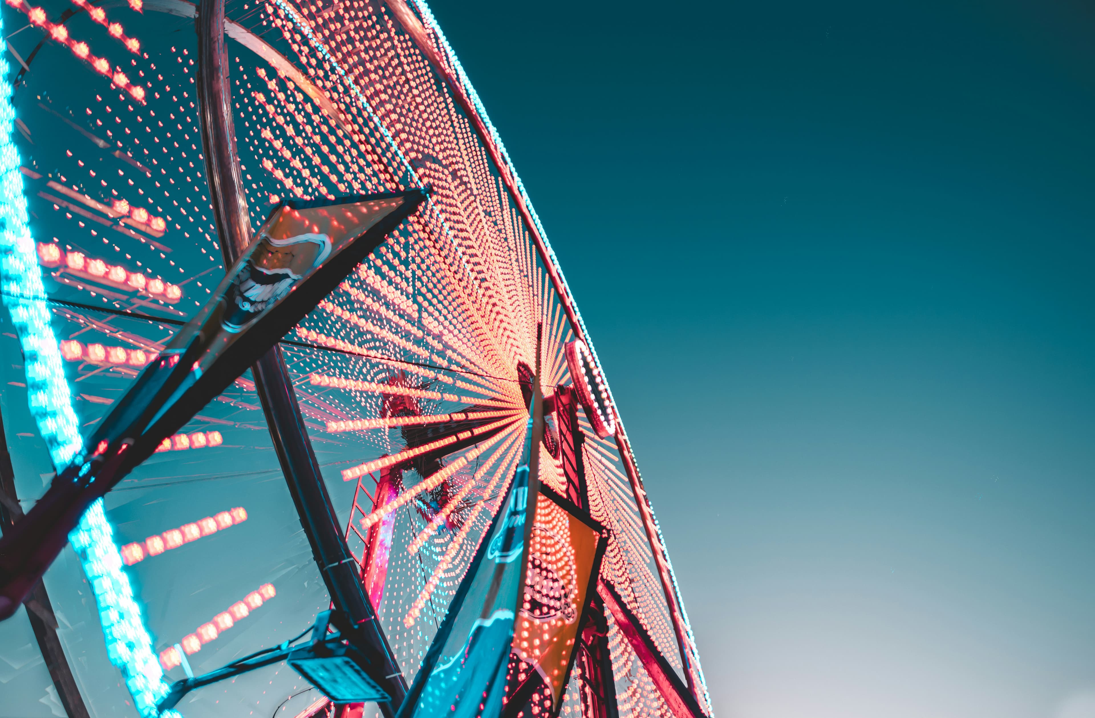 A lit carnival ferris wheel at night
