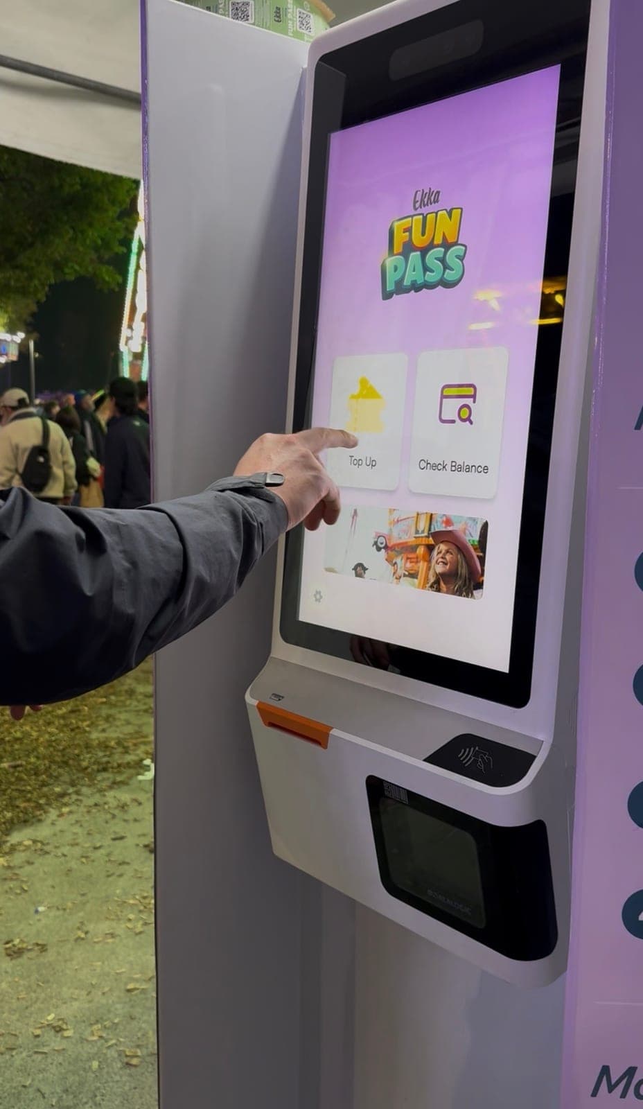 Closeup of a visitor using a Ludo self-service kiosk at the Ekka 2025